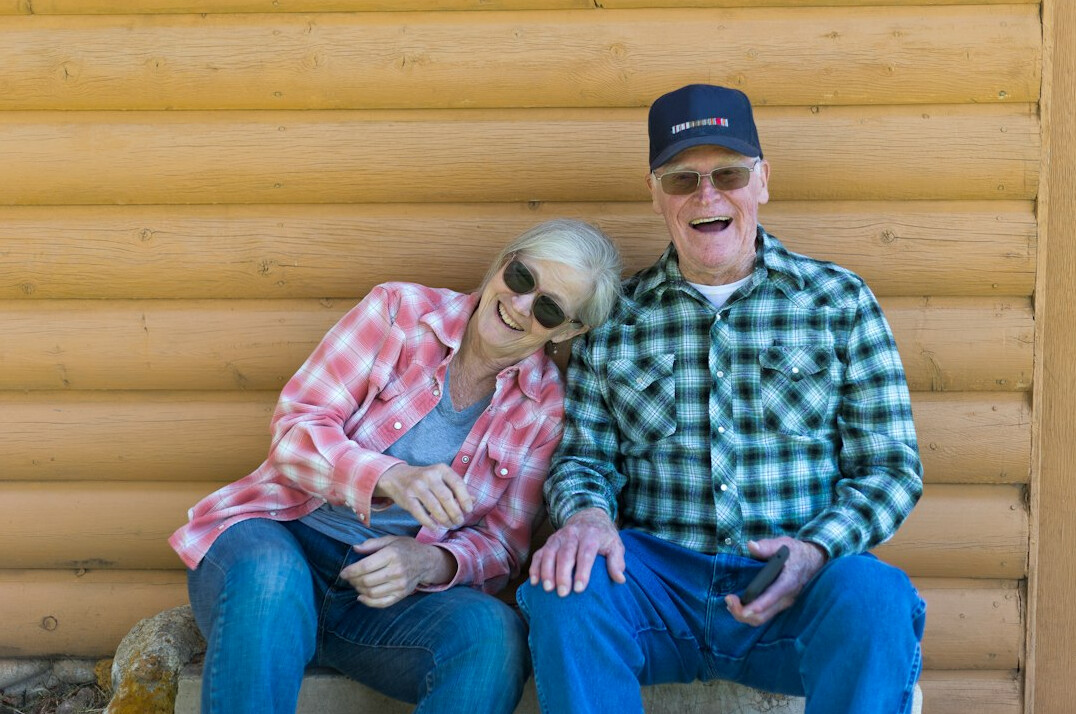 Elderly Malay Singaporean couple laughing together outdoors