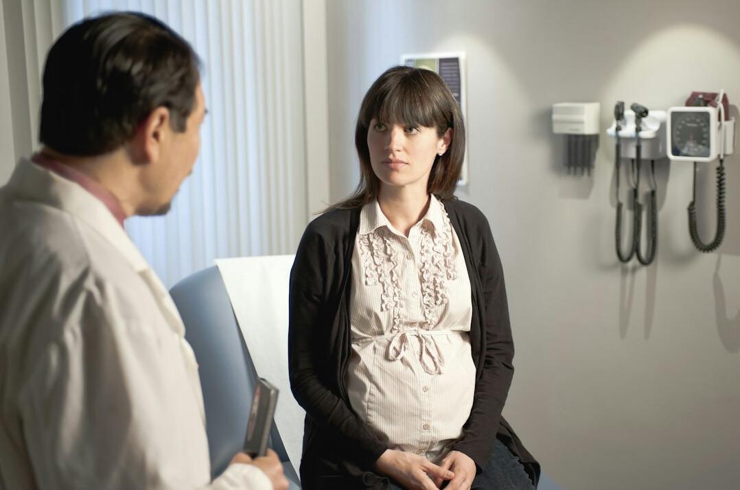 Chinese Singaporean pregnant woman consulting with her doctor