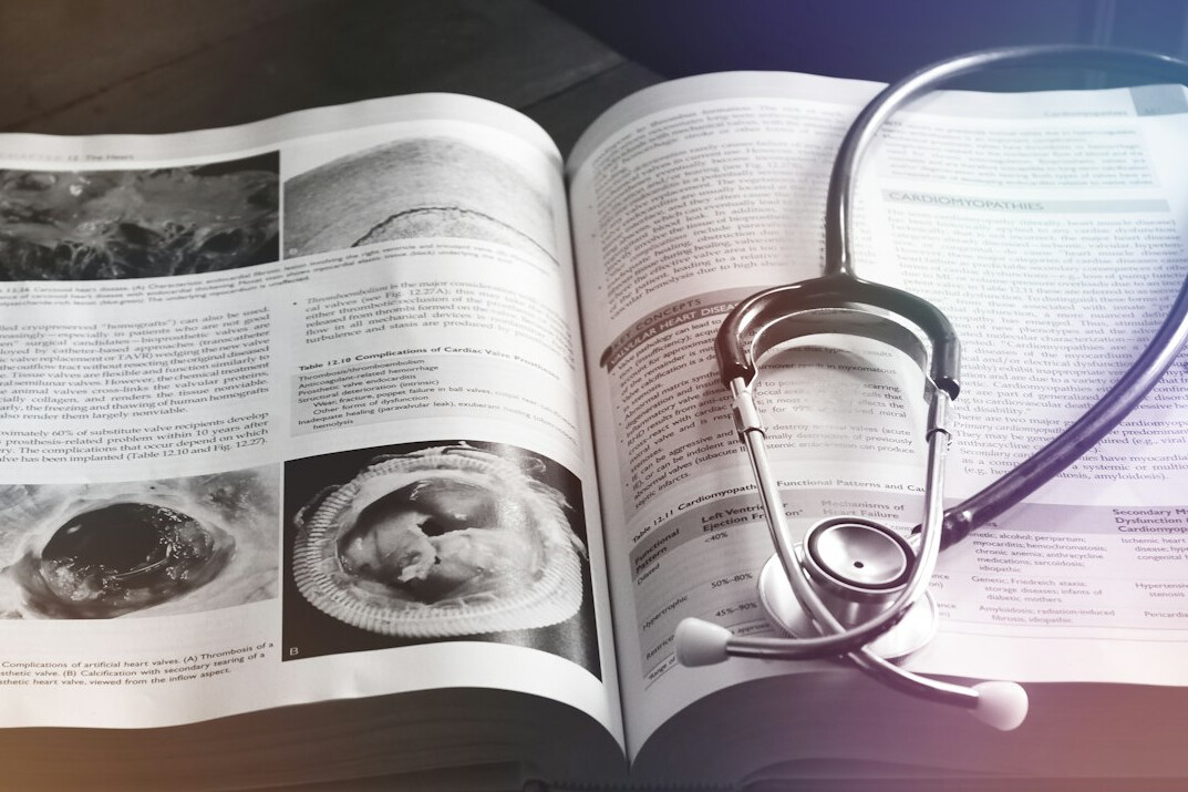 Flat lay of a stethoscope and medical insurance documents on a desk